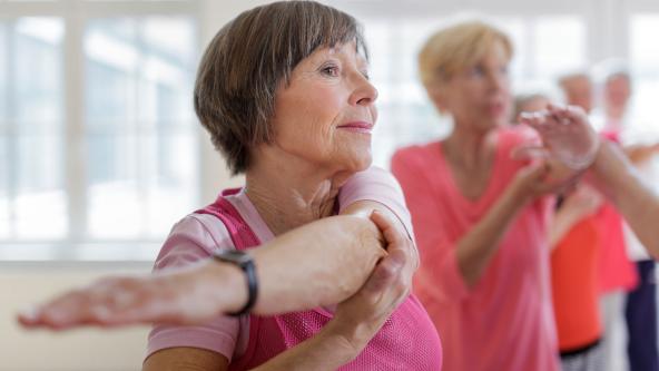 An exercise class, stretching.