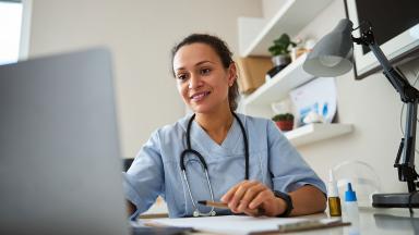 A doctor using a laptop.