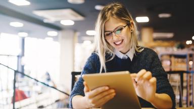 An office worker, working on a tablet.