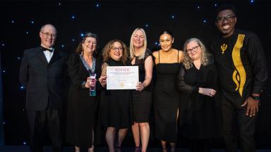 A group of guests receiving their award for the HPMA beyond boundaries awards