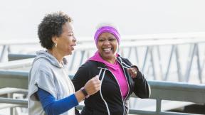 Two friends running and laughing.