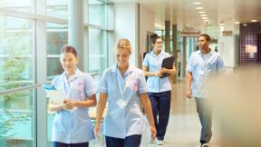 Student nurses walking along a corridor.