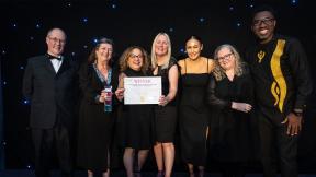 A group of guests receiving their award for the HPMA beyond boundaries awards