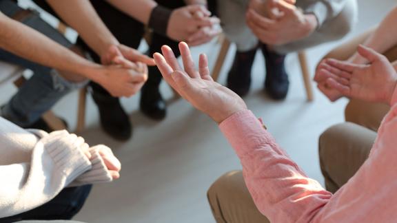 A close up of hands during a group discussion