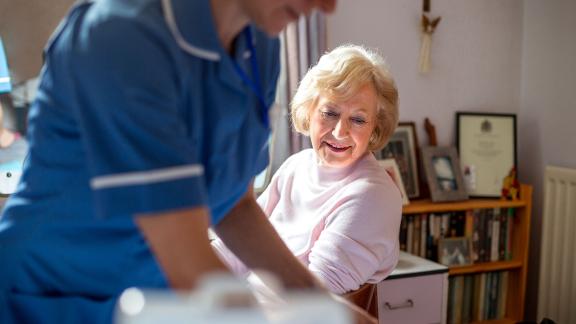 A nurse visiting a patient at home.