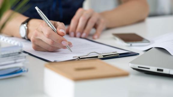 An office worker signing a form.