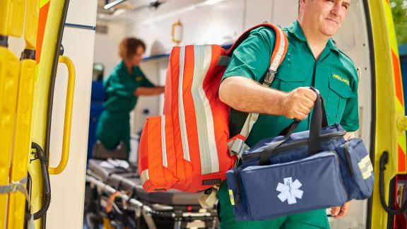 A paramedic leaving an ambulance.