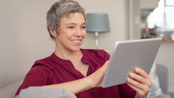 A woman using a computer tablet.