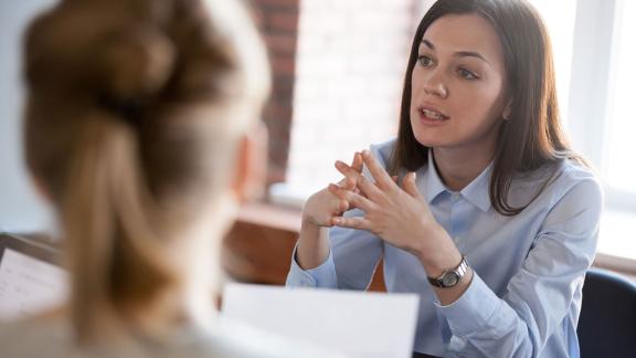 An officer worker speaking in a meeting.