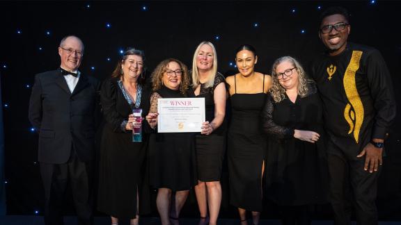 A group of guests receiving their award for the HPMA beyond boundaries awards