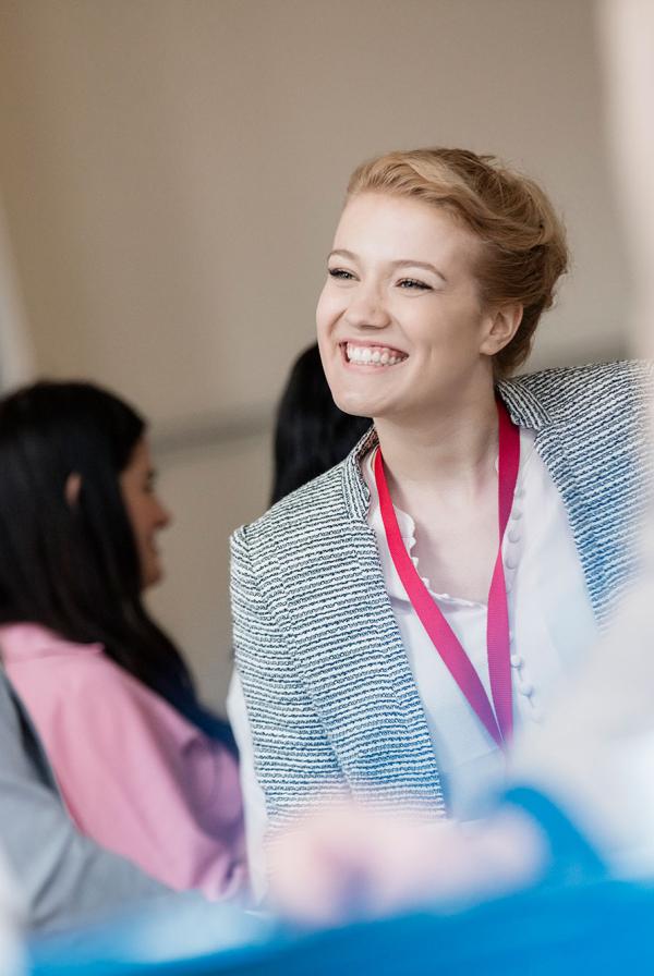 Participants in a breakout group smiling at each other.