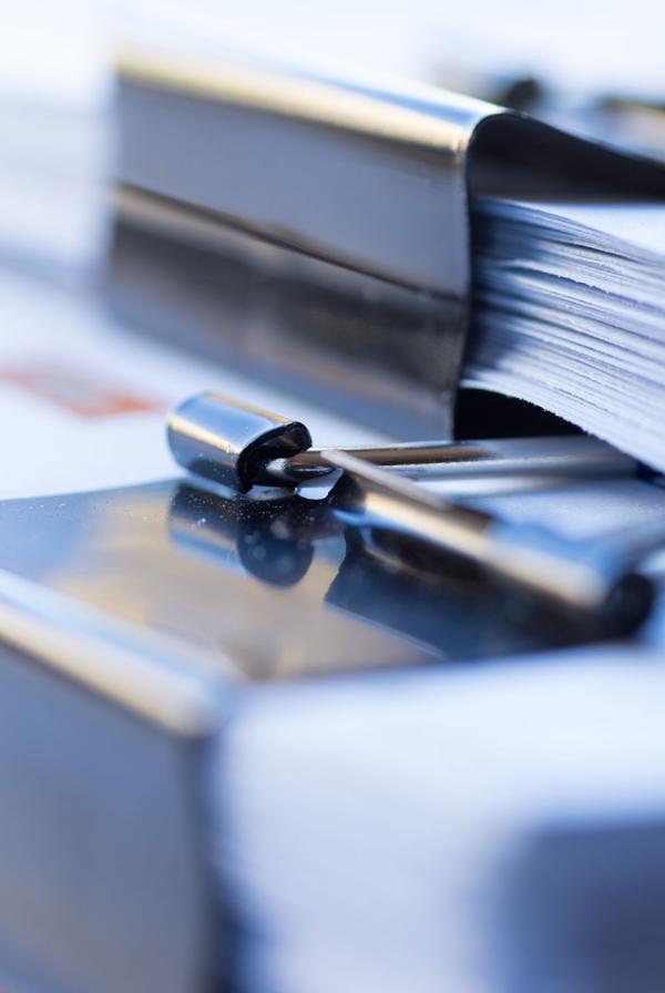 A stack of files held together with bulldog clips.