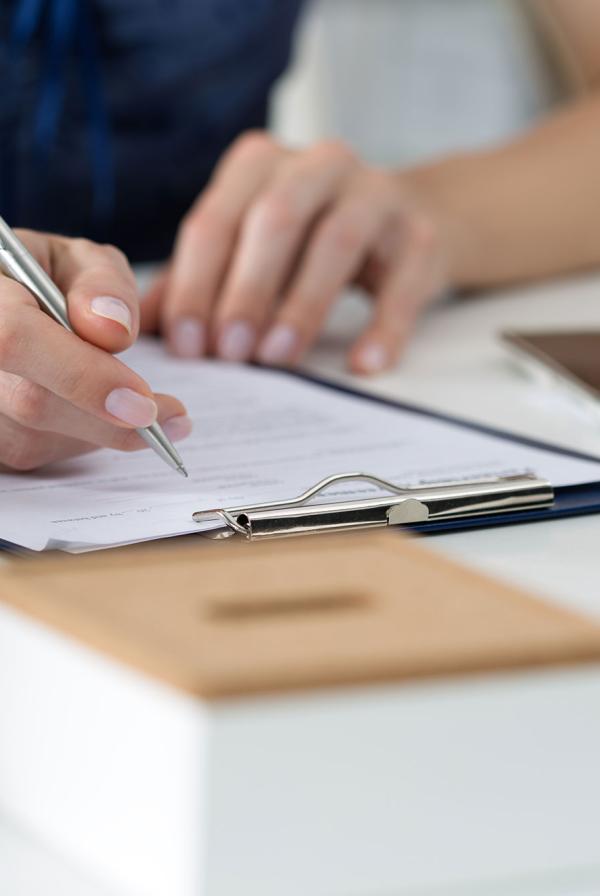 An office worker signing a form.