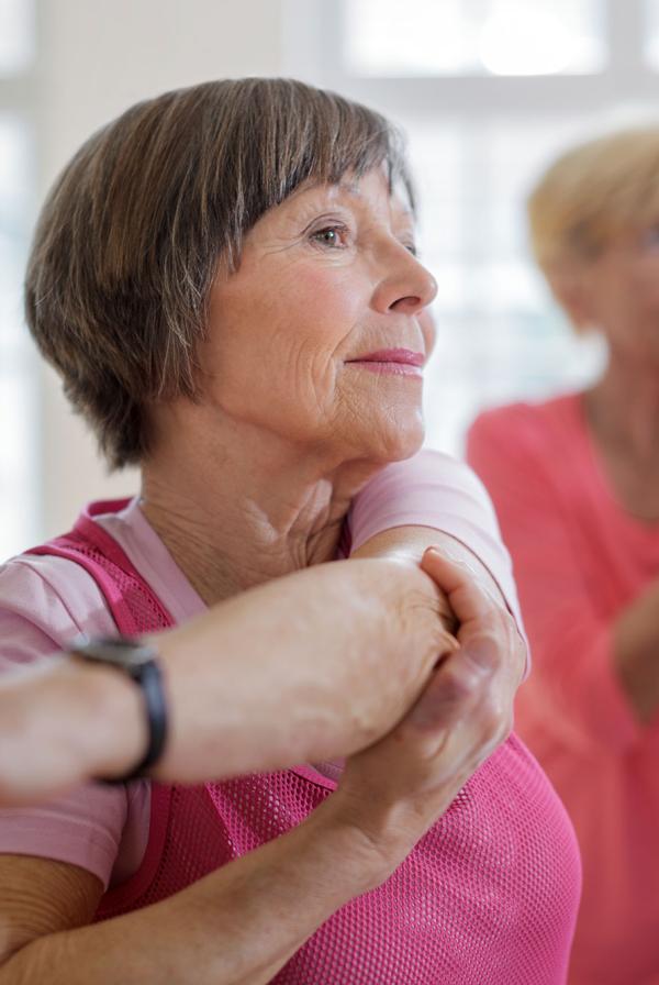 An exercise class, stretching.