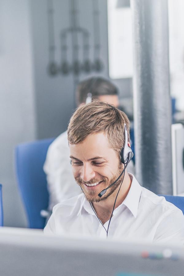 Image of people in an office on the phone using headsets