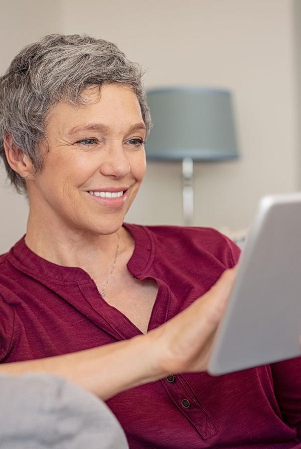 A woman using a computer tablet.